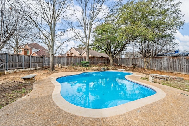 view of swimming pool with a fenced in pool, a fenced backyard, and a diving board