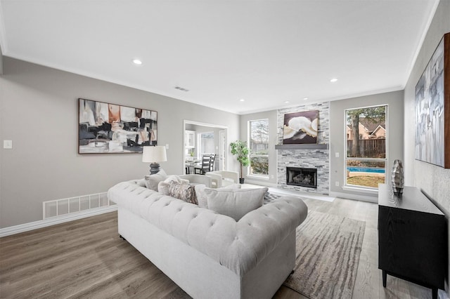 living room with a healthy amount of sunlight, visible vents, and wood finished floors