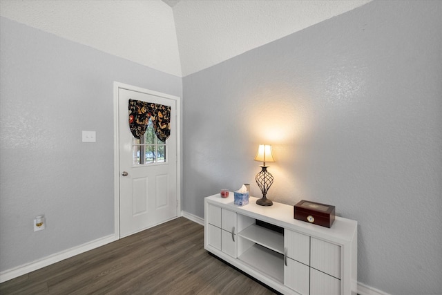 entryway featuring dark wood-style flooring and baseboards