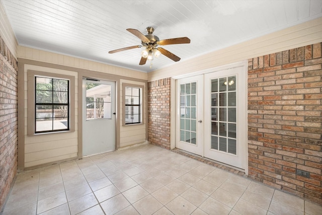 unfurnished sunroom with ceiling fan and french doors