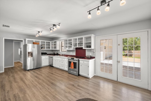 kitchen featuring visible vents, appliances with stainless steel finishes, french doors, light wood-style floors, and open shelves