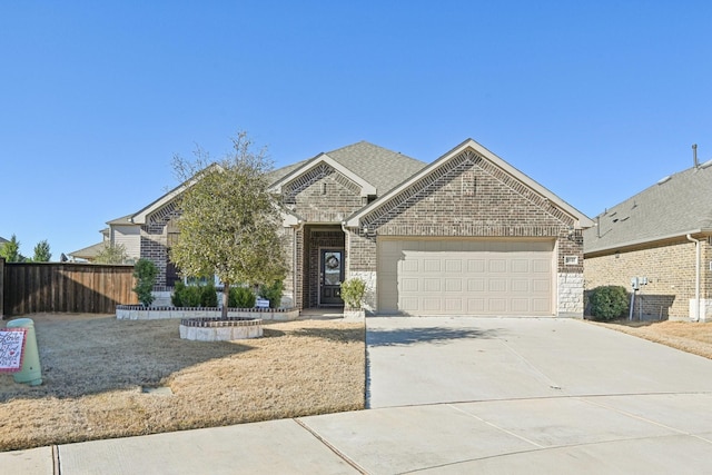 view of front of property featuring concrete driveway, roof with shingles, an attached garage, fence, and brick siding