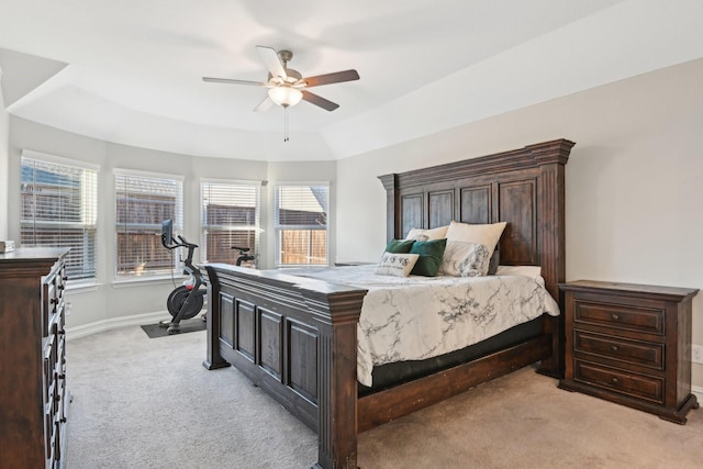 bedroom featuring light carpet, a ceiling fan, and baseboards