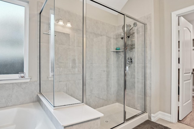 full bathroom featuring a garden tub and a shower stall