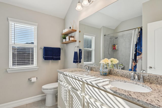 full bathroom featuring a tile shower, a sink, toilet, and tile patterned floors