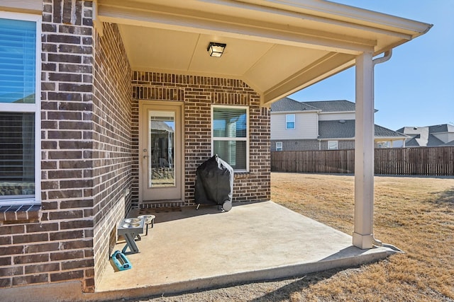 view of patio with area for grilling and fence