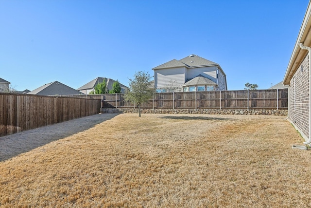 view of yard with a fenced backyard