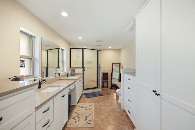 928 N Irving Heights Dr, Irving, TX 75061 - full bath with a stall shower, toilet, stone finish floor, vanity, and recessed lighting