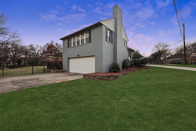 view of side of property featuring a garage, concrete driveway, a chimney, fence, and a yard