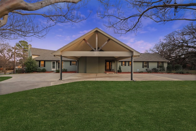 928 N Irving Heights Dr, Irving, TX 75061 - back of house with driveway, a shingled roof, and a lawn