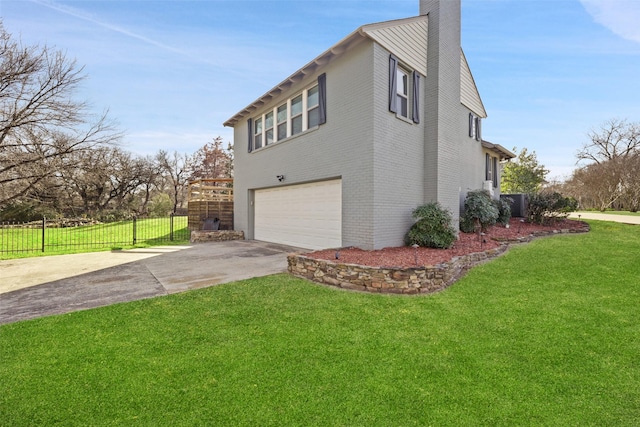 928 N Irving Heights Dr, Irving, TX 75061 - view of property exterior with an attached garage, brick siding, a yard, driveway, and a chimney
