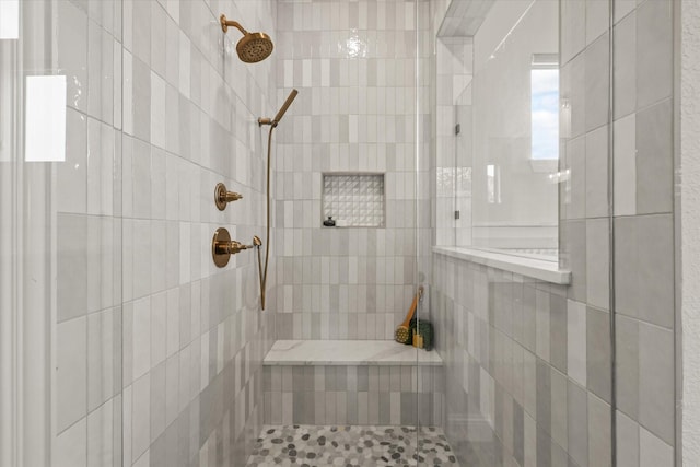 full bath featuring tiled shower