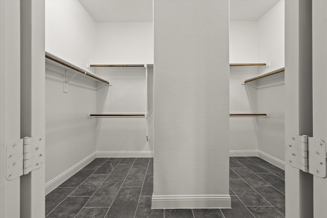 spacious closet featuring dark tile patterned floors