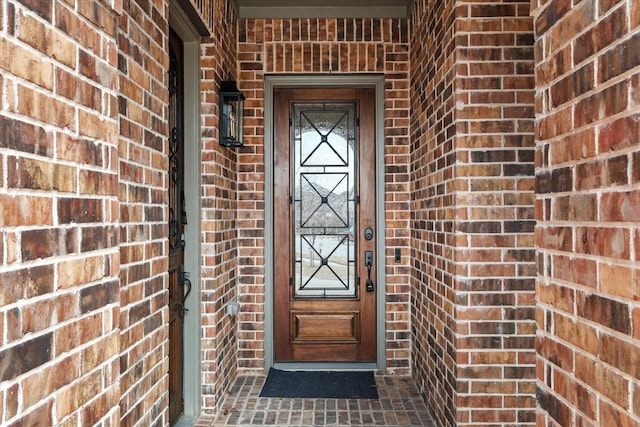 entrance to property with brick siding