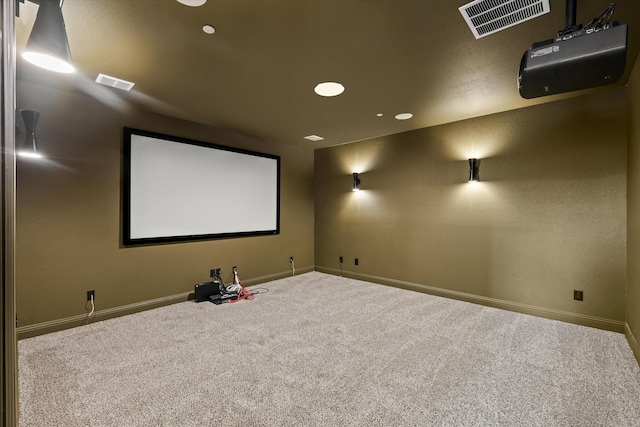 carpeted home theater featuring visible vents and baseboards