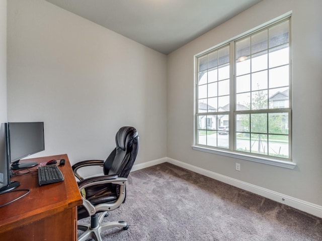 carpeted home office with baseboards