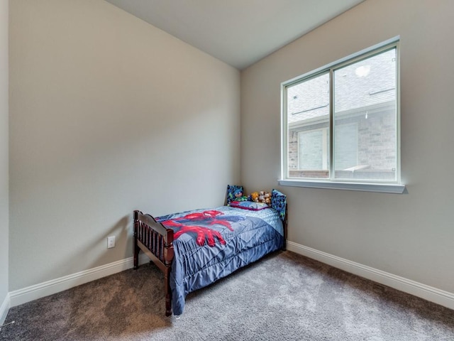 carpeted bedroom featuring baseboards