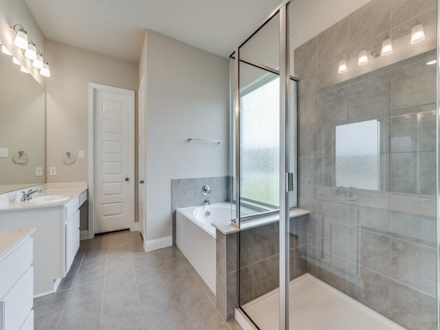 full bathroom featuring a stall shower, baseboards, a garden tub, tile patterned flooring, and vanity