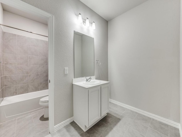 bathroom with tile patterned floors, vanity, toilet, and baseboards