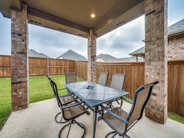 view of patio with a fenced backyard, visible vents, and outdoor dining area