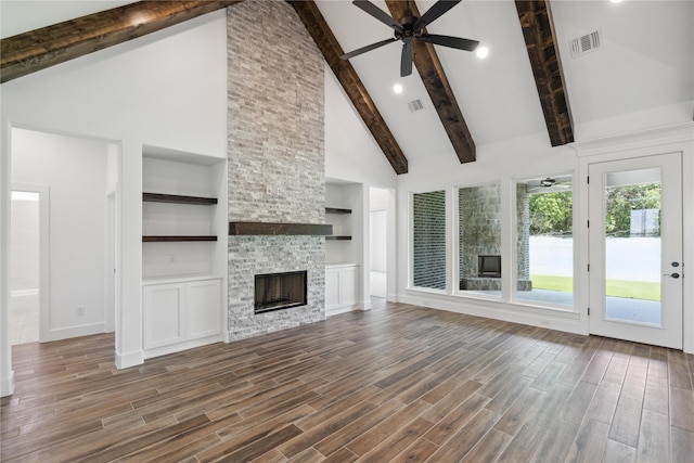 unfurnished living room featuring ceiling fan, wood finish floors, a fireplace, and visible vents