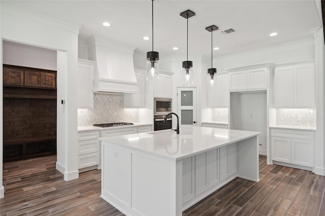 kitchen with appliances with stainless steel finishes, visible vents, custom exhaust hood, and white cabinetry