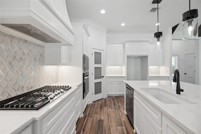 kitchen featuring a sink, white cabinetry, visible vents, appliances with stainless steel finishes, and custom range hood