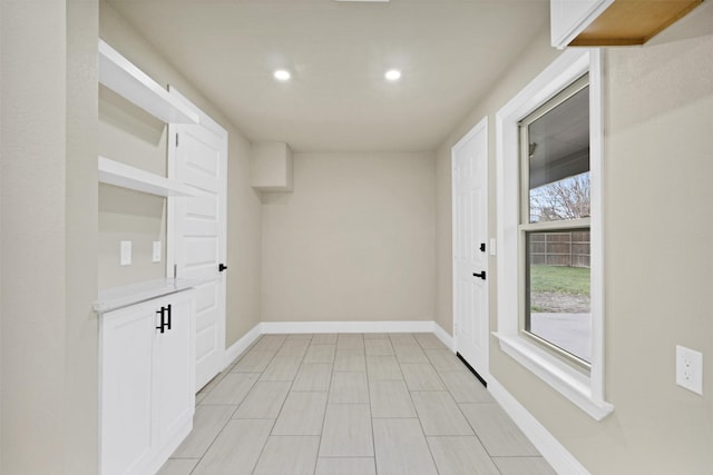 interior space featuring recessed lighting and baseboards