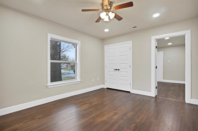 unfurnished bedroom with recessed lighting, visible vents, a ceiling fan, wood finished floors, and baseboards