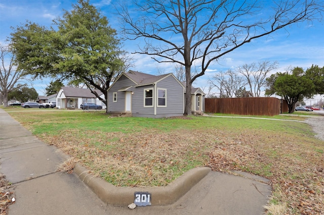 exterior space with a lawn and fence