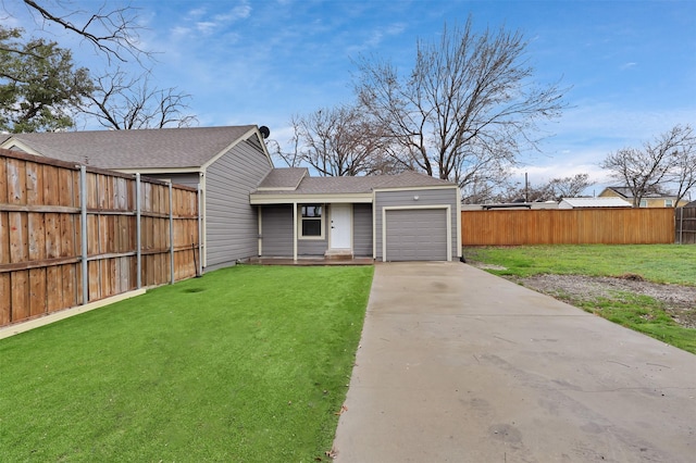 view of front of property featuring a garage, fence, driveway, roof with shingles, and a front lawn