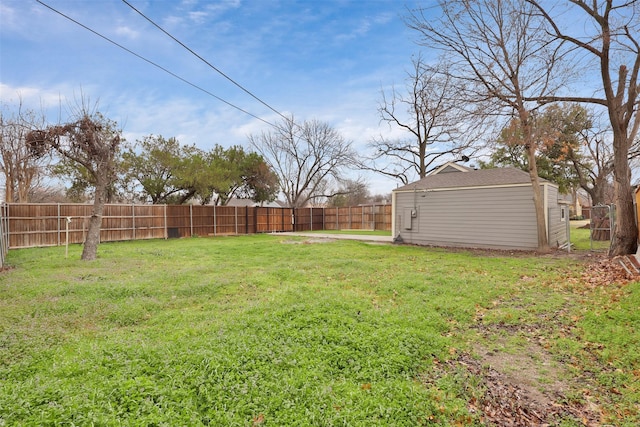 view of yard with an outbuilding and a fenced backyard