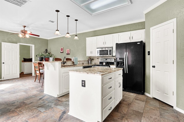 kitchen featuring a peninsula, stone finish flooring, visible vents, and stainless steel appliances