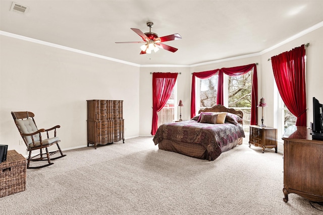 bedroom with carpet floors, ornamental molding, visible vents, and baseboards