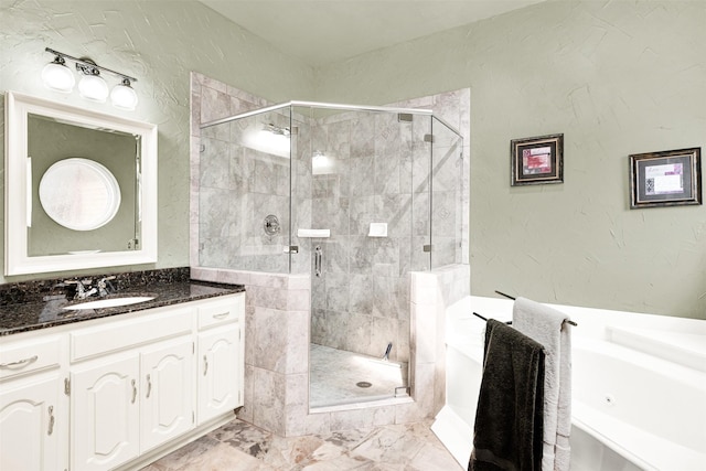 full bath with a textured wall, vanity, marble finish floor, a bath, and a stall shower