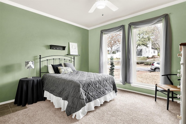 bedroom with a ceiling fan, carpet, crown molding, and baseboards