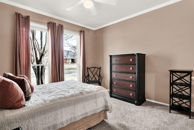 carpeted bedroom with crown molding, baseboards, and ceiling fan