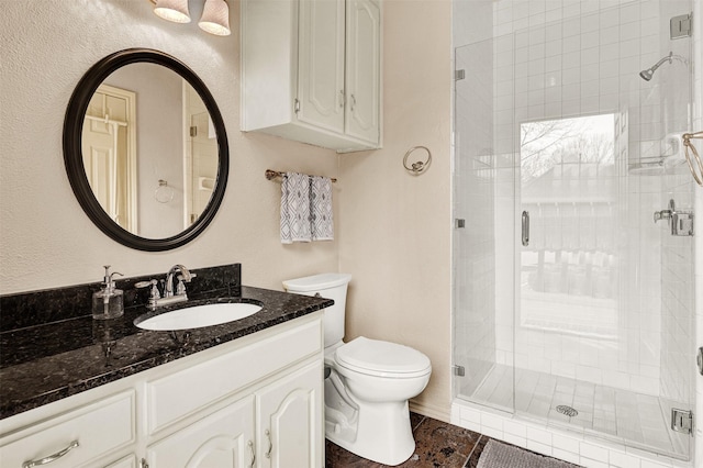 full bath featuring toilet, a shower stall, tile patterned flooring, and vanity