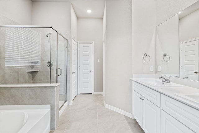 full bath with a garden tub, double vanity, a sink, a shower stall, and tile patterned floors