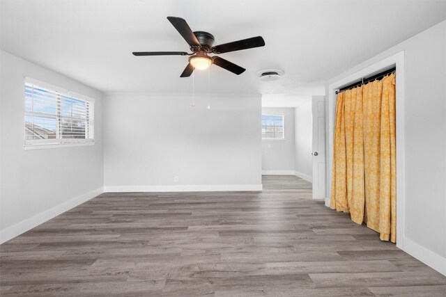 unfurnished room featuring wood finished floors and baseboards