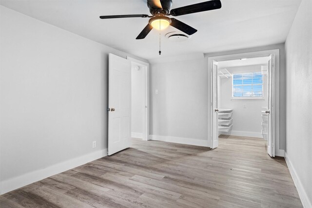 unfurnished bedroom with baseboards, ceiling fan, and light wood finished floors