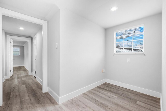 empty room featuring wood finished floors and baseboards