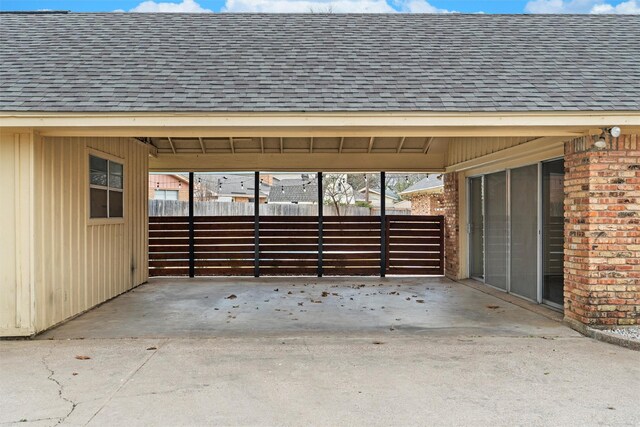 exterior space with a carport, driveway, and fence