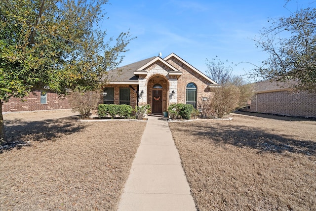 view of front facade featuring stone siding and brick siding