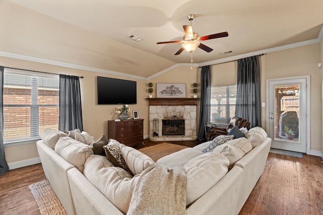 living area featuring lofted ceiling, wood finished floors, and visible vents