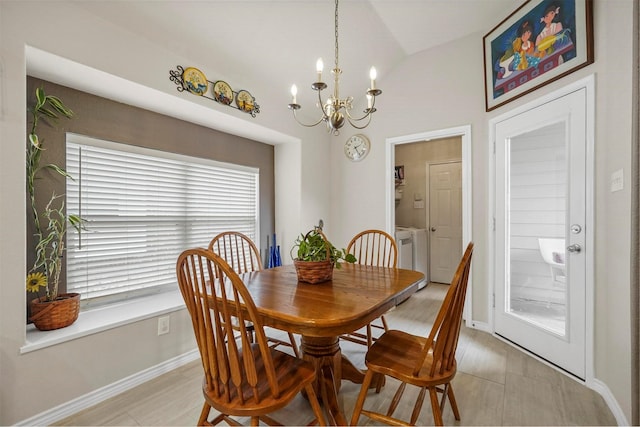 dining area featuring lofted ceiling, baseboards, and an inviting chandelier