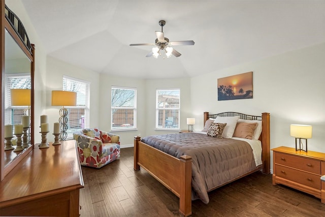 bedroom with vaulted ceiling, dark wood-type flooring, a ceiling fan, and baseboards