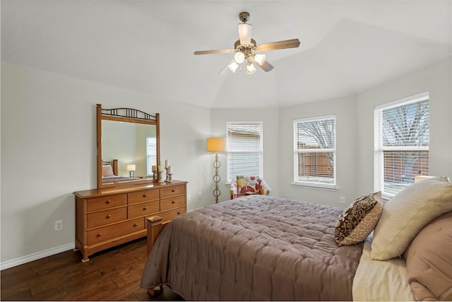 bedroom featuring a ceiling fan, lofted ceiling, dark wood finished floors, and baseboards