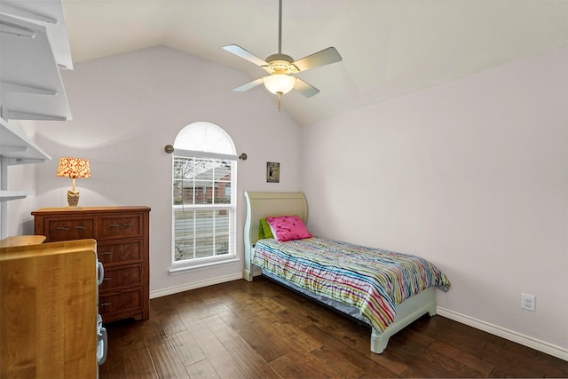 bedroom featuring a ceiling fan, lofted ceiling, baseboards, and wood finished floors