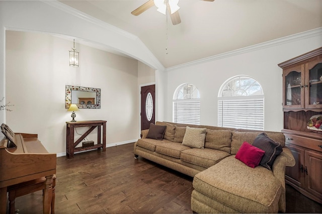 living area featuring dark wood-style flooring, a ceiling fan, baseboards, vaulted ceiling, and crown molding